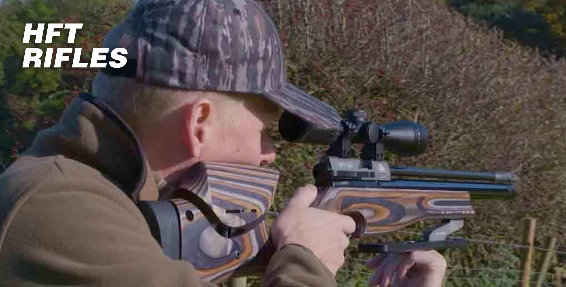 Person aiming a rifle outdoors, wearing a camo cap and jacket. Rifle has a scope and a wooden stock. Text reads "HFT Rifles".