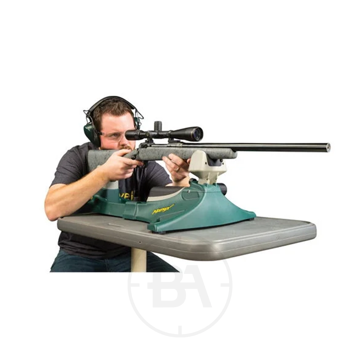 Caldwell Matrix Shooting Rest 5 A person with ear protection aims a scoped rifle supported by a Caldwell Matrix Shooting Rest on a table.