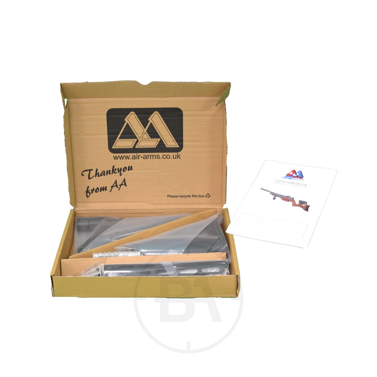 Air Arms AR Tactical Stock Assembly 5 Open cardboard box containing a disassembled Air Arms AR Tactical Stock Assembly, packaging materials, and a user manual placed beside the box.